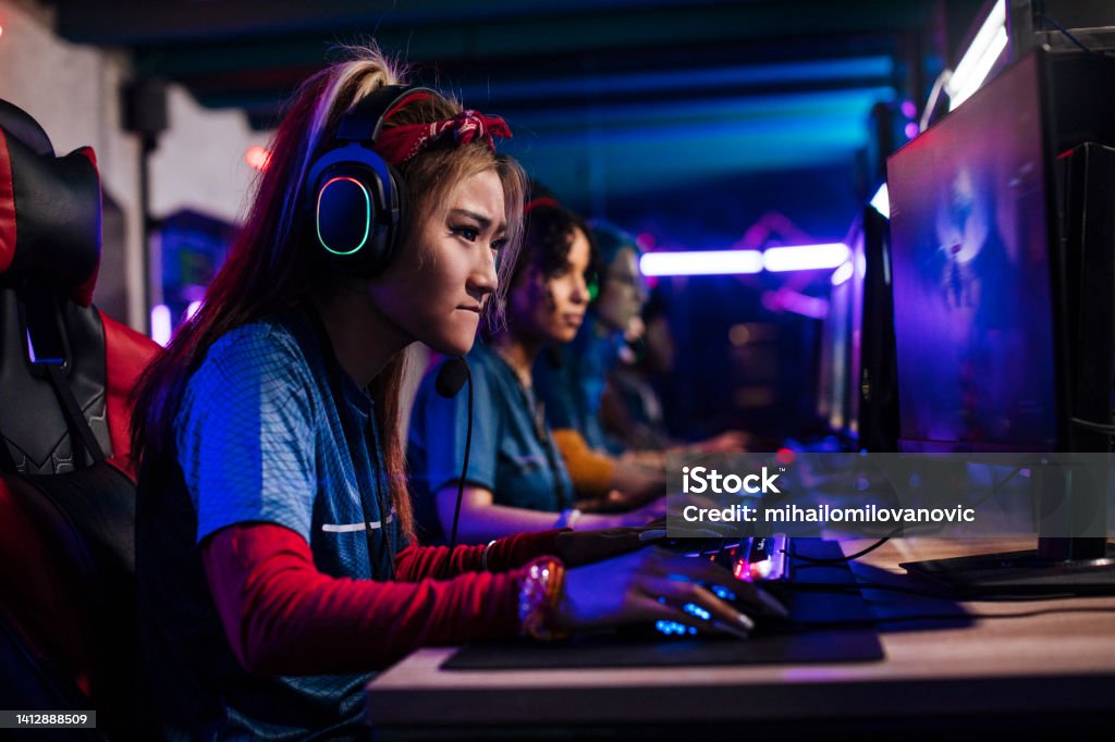Asian female gamer Chinese female gamer focus on playing games in the cybersport championship eSports Stock Photo
