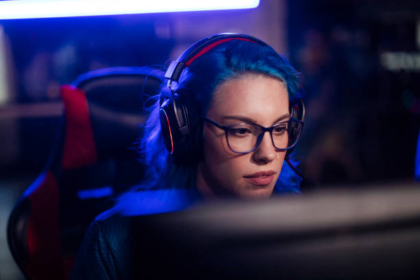 istock Beautiful young woman gamer 1412889148