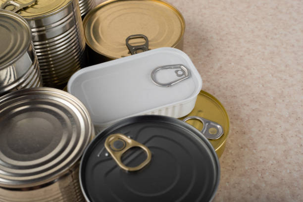 tin cans on kitchen table background with copy space - undernourishment imagens e fotografias de stock