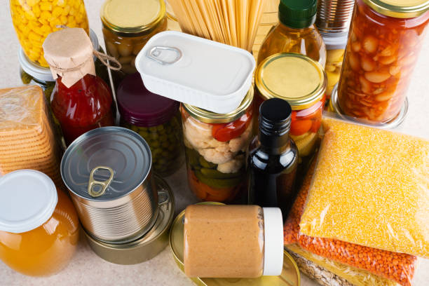istock Emergency survival food set on white kitchen table high angle view 1412889561