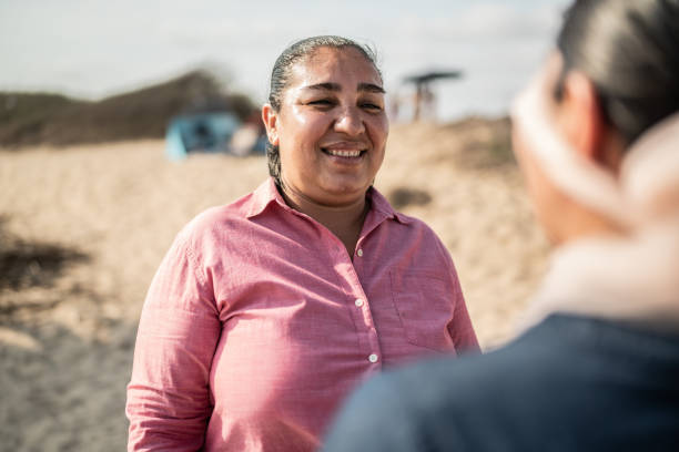 istock Woman making a surprise for her girlfriend on the beach 1412891836