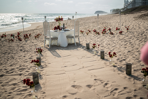 Dinner table for valentines day on the beach