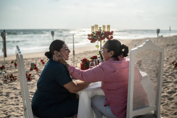istock Lesbian couple talking at a beach 1412891941