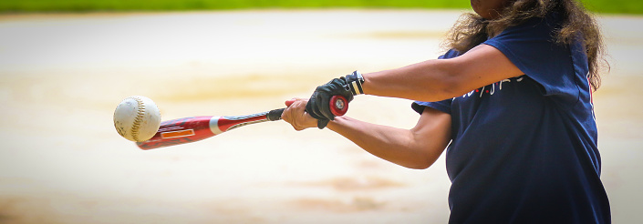 Baseball, baseball player and bat ball swing at a baseball field during training, fitness and game practice. Softball, swinging and power hit with athletic guy focus on speed, performance and pitch