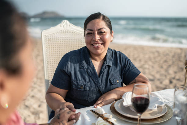istock Gay couple on a romantic dinner at the beach 1412892034