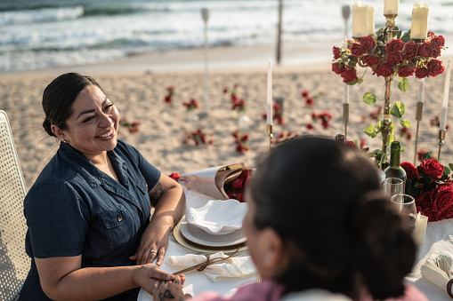 Lesbian couple on a romantic date at the beach