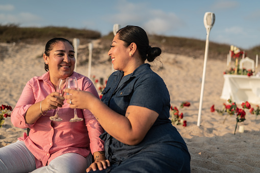 Lesbian couple on a romantic date on the beach