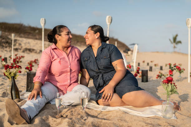 istock Lesbian couple on a romantic date on the beach 1412892210