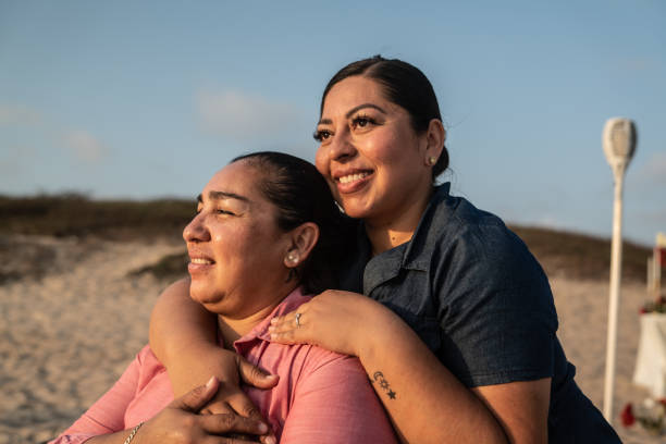 istock Lesbian couple on a romantic date contemplating at the beach 1412892302