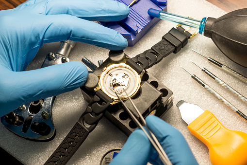 Watchmaker replacing battery in quartz watch, Watch maintenance service.