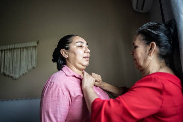 istock Mother helping daughter getting dressed at home 1412893382