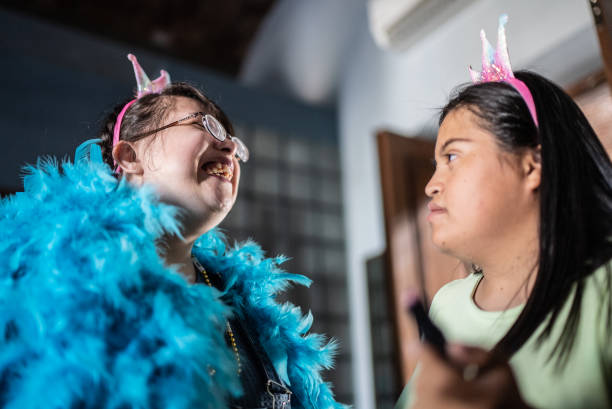 Special needs friends getting putting on makeup in the bedroom at home