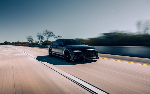 LA, CA, USA\nJuly 28, 2022\nMatte Black Audi RS7 driving on the highway with no cars around