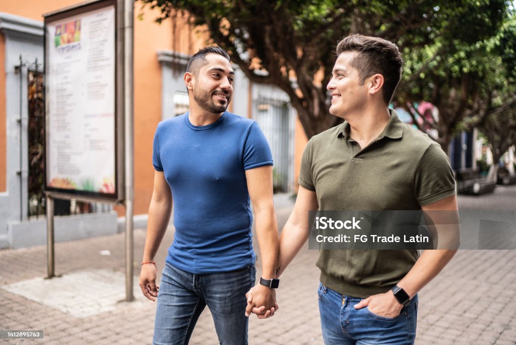 Young gay couple walking at the historic district Latin American and Hispanic Ethnicity Stock Photo