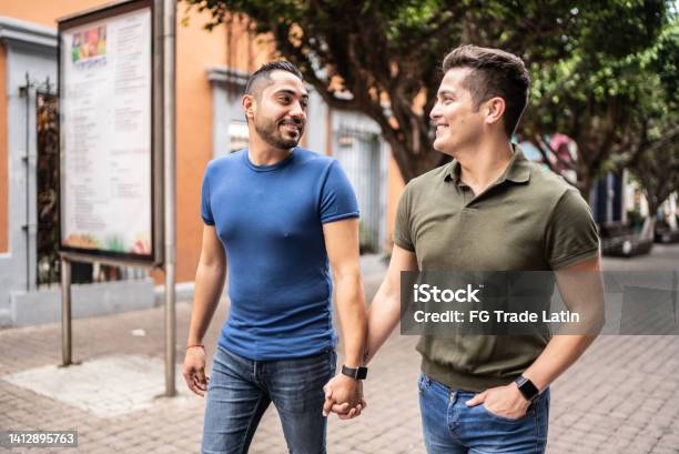 Young Gay Couple Walking At The Historic District Stock Photo - Download Image Now - Latin American and Hispanic Ethnicity, Gay Man, Couple - Relationship