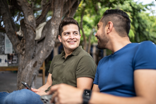 Young gay couple talking outdoors