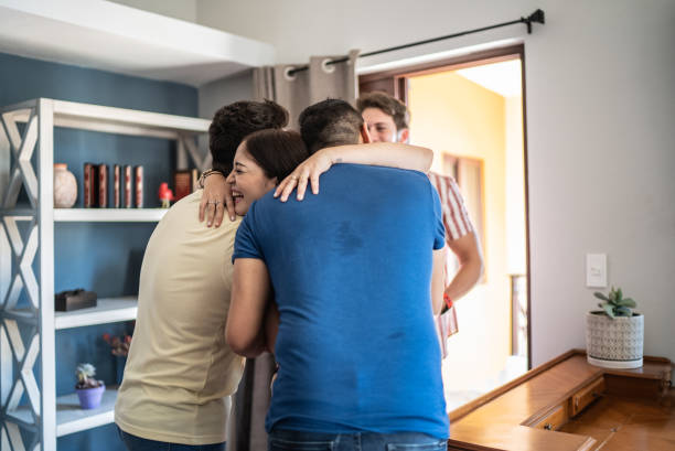 istock Friends arriving for social gathering and embracing 1412896743