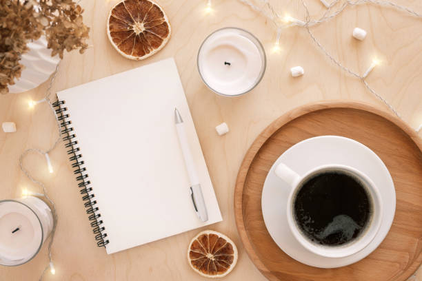 istock Back to life, goal list concept. Woman's hand writing in empty notebook on wooden table. Resolutions, plan, goals, checklist, idea concept. Top view, flat lay, copy space. 2022. Christmas, New Year 1412896752