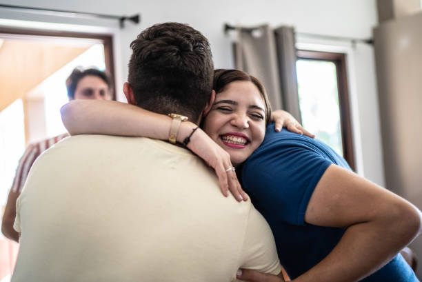 istock Friends arriving for social gathering and embracing 1412896759