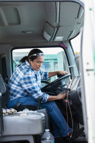 istock Hispanic woman driving truck, starting engine 1412897482