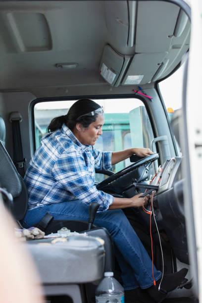 istock Hispanic woman driving truck, starting engine 1412897483