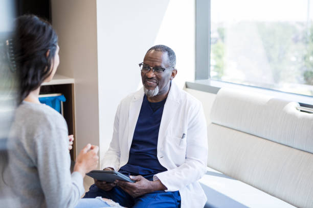 istock Doctor listens carefully as woman gestures while describing symptoms 1412897683