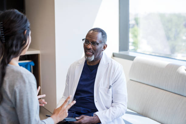 istock Male doctor asks patient questions about symptoms 1412897705