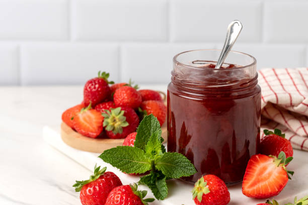 istock Strawberry jam in glass jar and fresh strawberries 1412898820