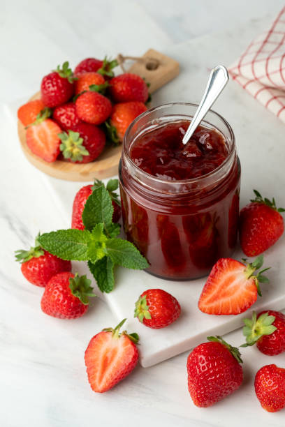 istock Strawberry jam in glass jar and fresh strawberries 1412898965