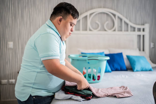 istock Special needs mid adult man folding clothes 1412899442