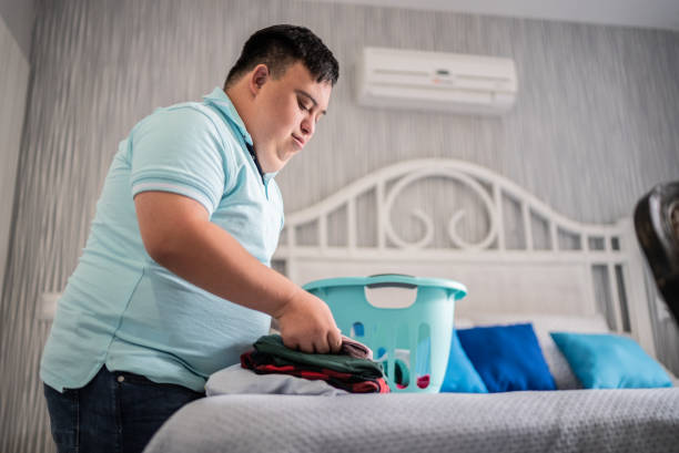 istock Special needs mid adult man folding clothes 1412899474