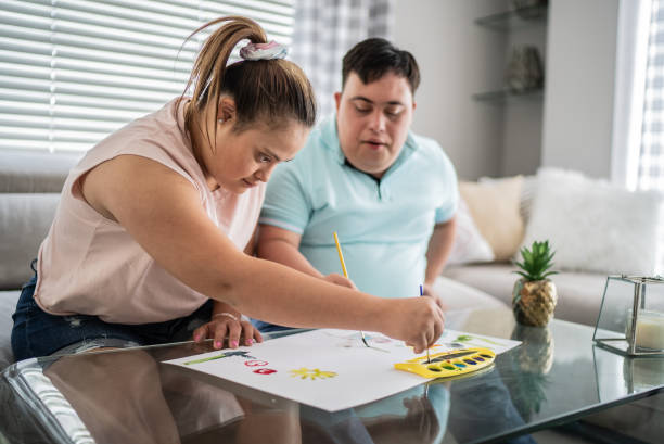 istock Couple with special needs painting at home 1412899495