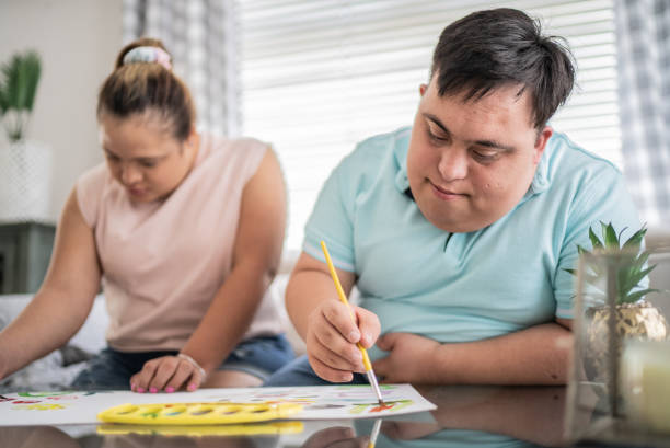 istock Couple with special needs painting at home 1412899513