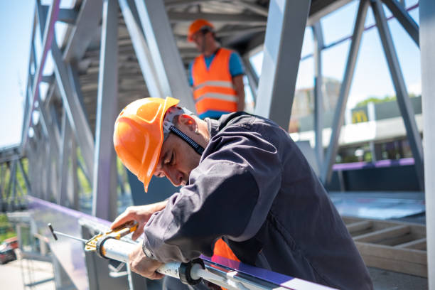 istock A worker puts glue for mounting exterior aluminum composite panels 1412900667