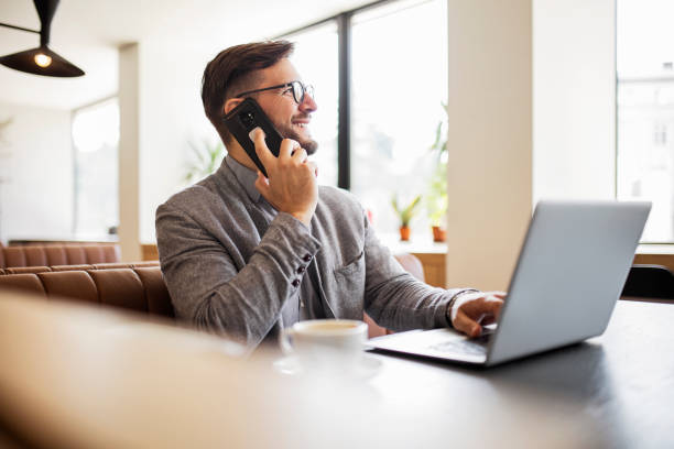 istock Businessman working in the morning during coffee break using phone 1412900889