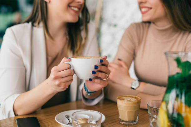 istock two woman friends in cafeteria 1412900970