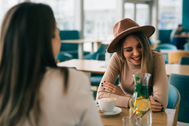 istock two woman friends in cafeteria 1412901051