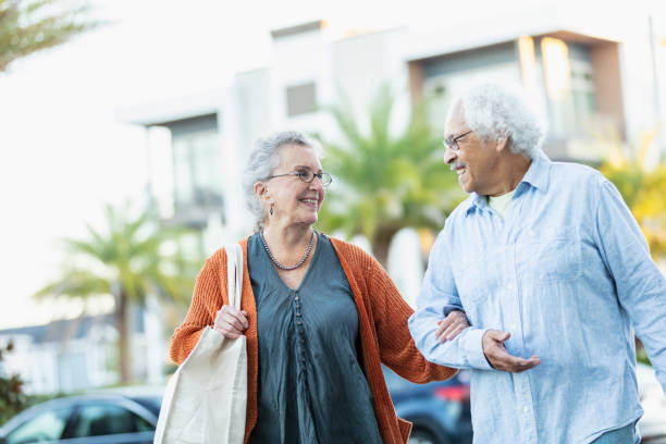 istock Multiracial senior couple walking outdoors arm in arm 1412902429