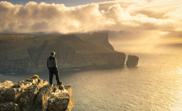 Mýlingur from Eiðiskollur Looking out towards the dramatic sea cliff of Mýlingur from near the summit of Eiðiskollur on Eysturoy in the Faroe Islands. eysturoy stock pictures, royalty-free photos & images