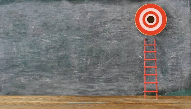 istock Stand out from the crowd and think different. Creative idea concepts with red ladder and ambitious target with copy space on blackboard 1412903041