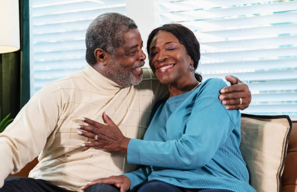 istock Senior African-American couple hugging on couch 1412903734