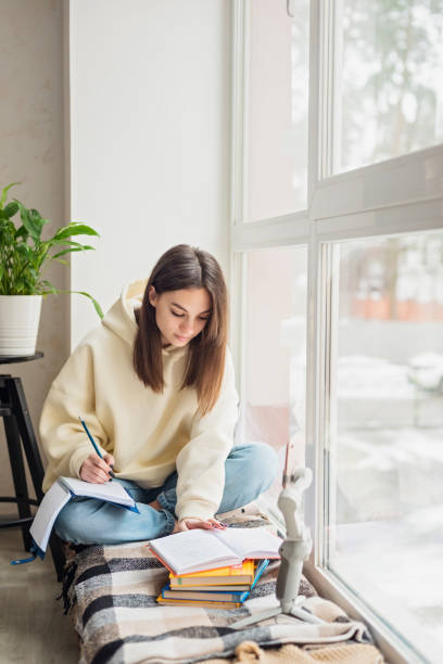 teen school girl distant school or college student virtual remote e learning using mobile phone app in bedroom. distance education classes, studying online at home concept. soft selective focus. - homework teenager mobile phone school imagens e fotografias de stock