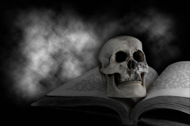 Skull on the old book with a dark smoky cloud for the black magic Halloween concept