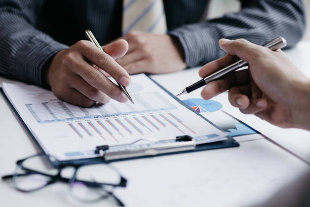 istock Two businessmen pointed to the material for the meeting, working together to plan to develop and solve common business problems. Concept of business management for growth and quality. 1412907596