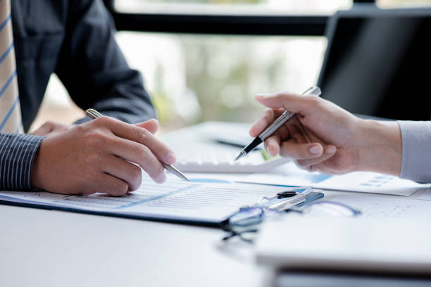 istock Two businessmen pointed to the material for the meeting, working together to plan to develop and solve common business problems. Concept of business management for growth and quality. 1412907722