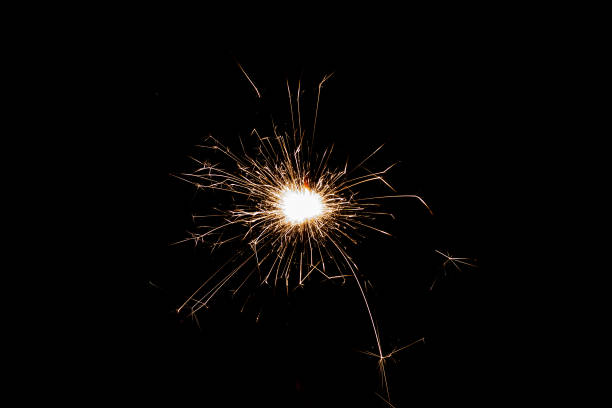 istock Burning sparkler isolated on black background. Fireworks theme. Light effect and texture. 1412909281