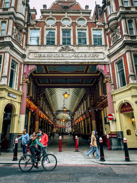 London, England -  5th June, 2022: Cyclist and pedestrians at the front entrance of Leadenhall Market