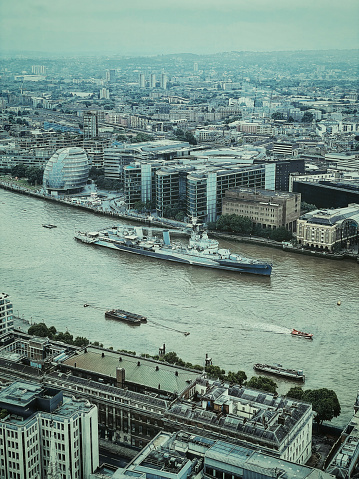 London, England - 5th June 2022: Aerial view of HMS Belfast on River Thames on a rainy day