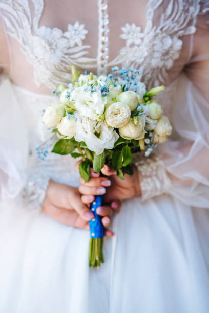 istock the bride is holding a wedding bouquet 1412910897