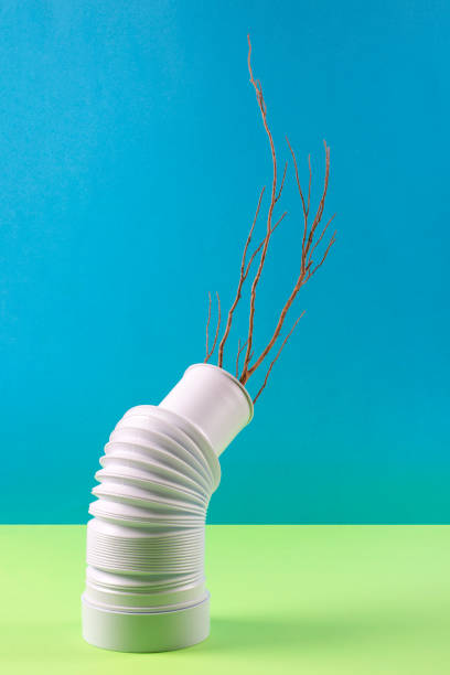 istock Still life with a white vase with a tree branch on a colored background 1412915983